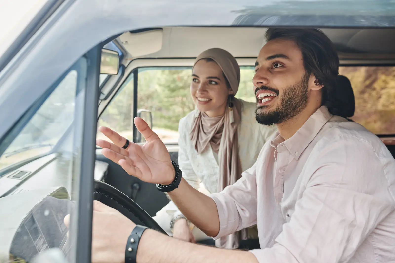 A driver talking with the passenger beside him